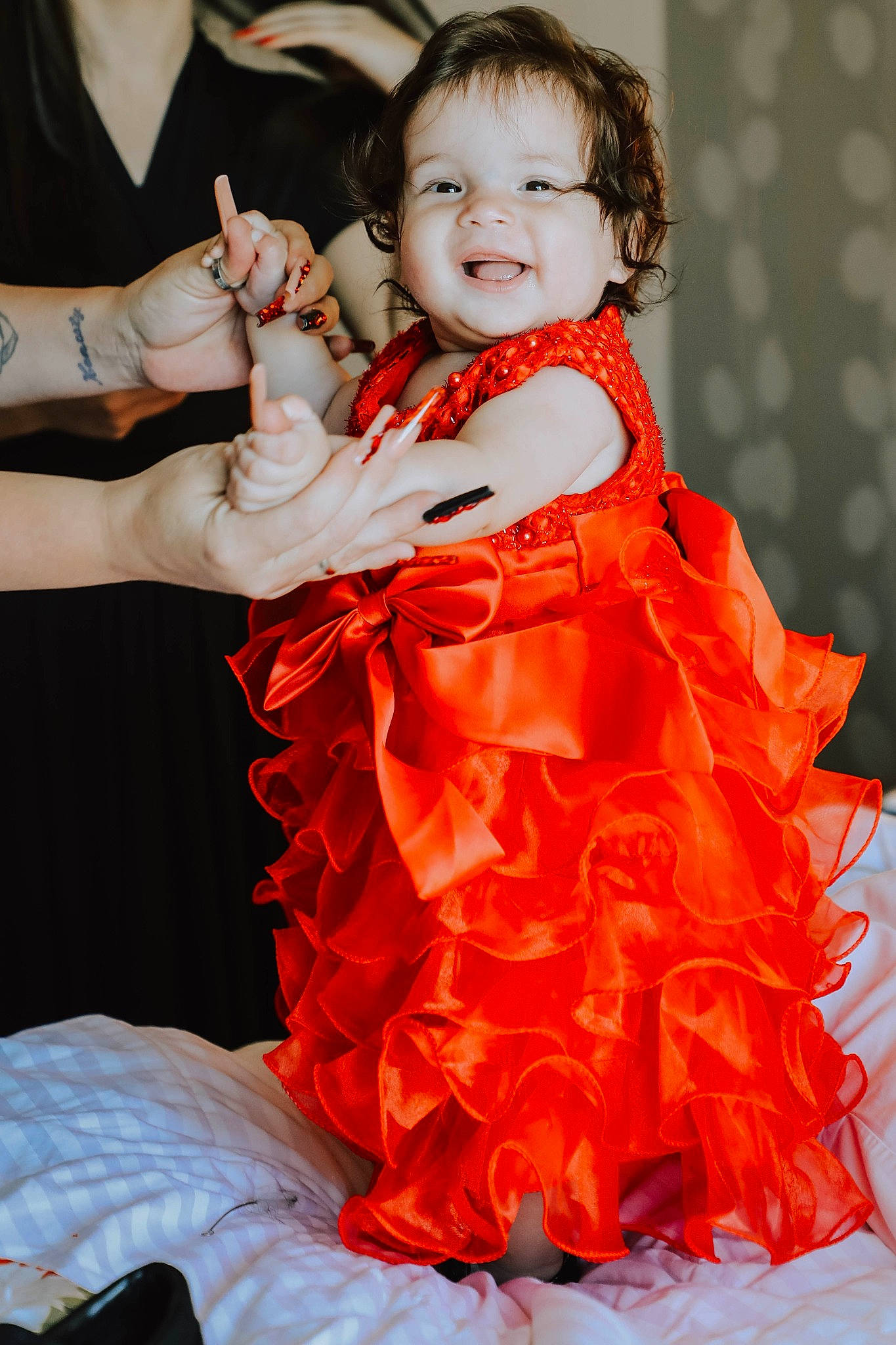 Reyna is registered to the contest to win money with this photo: arm, baby, baby_toddler_clothing, child, day_dress, dress, entertainment, face, fashion_design, formal_wear, gesture, gown, happy, joy, one_piece_garment, orange, performing_arts, person, ruffle, sleeve