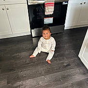 Willow joined the competition — help win amazing prizes! baby, pajamas, kitchen, floor, oven, cabinets, stainless_steel, smile, child, indoor, appliance, towel, wood_floor, person, home, footwearless, cabinet_knobs, curly_hair, infant, cute