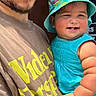 arm, blue_dress, bucket_hat, casual, child, clothing, daylight, expression, face, happy, hat, holding, man, outdoor, person, portrait, skin, smile, toddler, watch