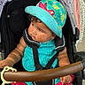 baby, casual, child, curly_hair, cute, hat, infant, monkey, outdoor, pink, playful, portrait, safety_harness, seat, stroller, summer_clothing, sunlight, toddler, toy, turquoise