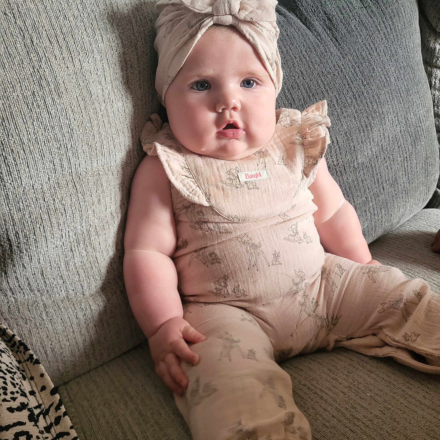 Evelyn is registered to the contest to win money with this photo: baby, bodypart, bonnet, cap, clothing, couch, cushion, face, finger, furniture, hand, hat, head, homedecor, linen, pants, person, photography, portrait, sitting