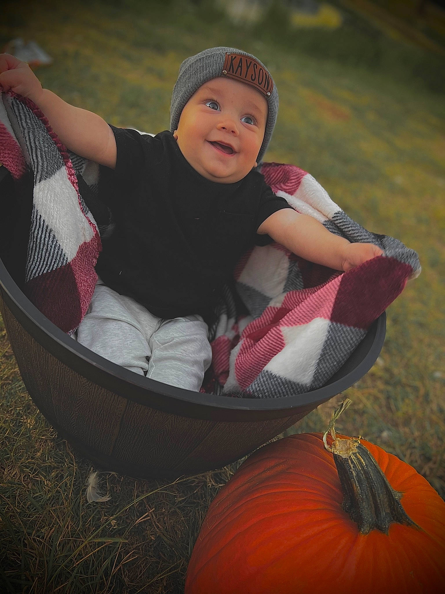 Kayson is registered to the contest to win money with this photo: baby, baby_toddler_clothing, calabaza, chair, cucurbita, flash_photography, gourd, grass, happy, headwear, leisure, people_in_nature, person, plant, pumpkin, recreation, smile, squash, toddler, tree