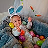 baby, infant, child, bunny_hat, smiling, portrait, lying_down, ball_pit, colorful_balls, blue_blanket, soft_bedding, onesie, toys, indoor, nursery, playtime, happy, face, rabbit_ears, cozy