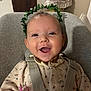 baby, smiling, happy, face, infant, child, leaf_crown, seatbelt, baby_seat, clothing, indoors, cute, portrait, cheerful, young_child, head, eyes, mouth, skin, person