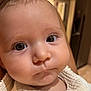 Lou participe au concours pour gagner de l'argent avec cette photo : baby, face, closeup, infant, eyes, expression, skin, cheeks, clothing, indoor, person, portrait, cute, young, head, curious, soft, warm, child, newborn