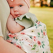 Everleigh joined the competition — help win amazing prizes! baby, child, infant, headband, pink_bow, floral_dress, holding, arm, outdoor, greenery, portrait, cute, person, skin, face, closeup, summer, nature, soft_light, tenderness