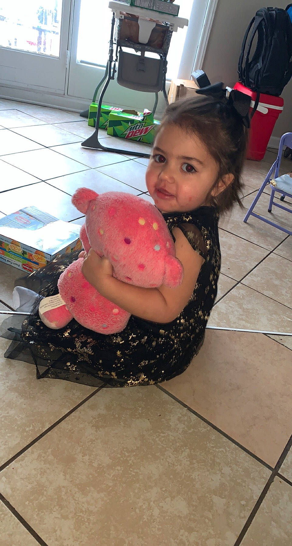 Adalynn is registered to the contest to win money with this photo: chair, child, computer_keyboard, floor, flooring, fun, human_leg, icing, joint, leisure, luggage_and_bags, magenta, person, sandal, sitting, thigh, toddler, toy