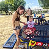 Keagan joined the competition — help win amazing prizes! child, woman, birthday_cake, picnic_table, outdoor, park, trees, grass, party, celebration, food, messy, smile, casual_clothing, balloons, gift_bags, sunny_day, people, summer, fun