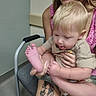 Keagan joined the competition — help win amazing prizes! child, adult, tattoo, chair, indoor, person, baby, blonde_hair, foot, hand, sitting, clothing, skin, face, tongue, expression, casual, holding, floor, arm
