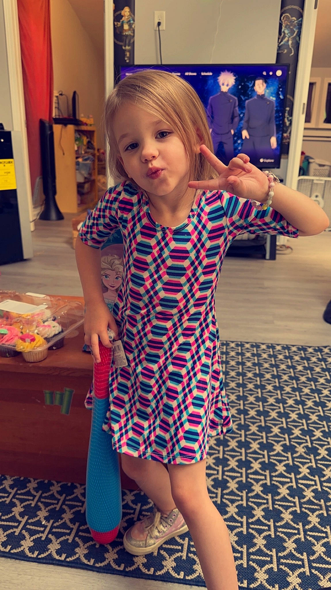 Kailynn is registered to the contest to win money with this photo: blue, electric_blue, floor, flooring, gesture, hair, happy, head, joint, knee, long_hair, neck, pattern, person, purple, sleeve, standing, t_shirt, thigh, toddler