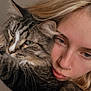 affection, animal, calm, cat, closeup, companionship, cute, face, fur, hair, indoor, nose_ring, person, pet, portrait, snuggling, soft_lighting, tabby_cat, warm_tones, whiskers