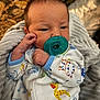 baby, infant, pacifier, onesie, animal_print, blanket, sleepwear, child, newborn, cute, soft, cozy, hand, face, portrait, indoors, resting, young, person, clothing