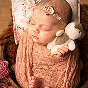 Charlie a rejoint le concours — aidez-le/la à gagner de superbes lots ! newborn, baby, sleeping, swaddled, plush_toy, headband, flower, pillow, wooden_bowl, soft_texture, pink_wrap, infant, cute, peaceful, portrait, closeup, tiny_feet, delicate, cozy, indoors