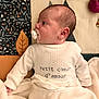 baby, infant, pacifier, blanket, soft_toy, white_clothing, patterned_blanket, lying_down, side_view, cute, child, newborn, cozy, indoors, warm, face, head, sleepwear, comfort, baby_girl