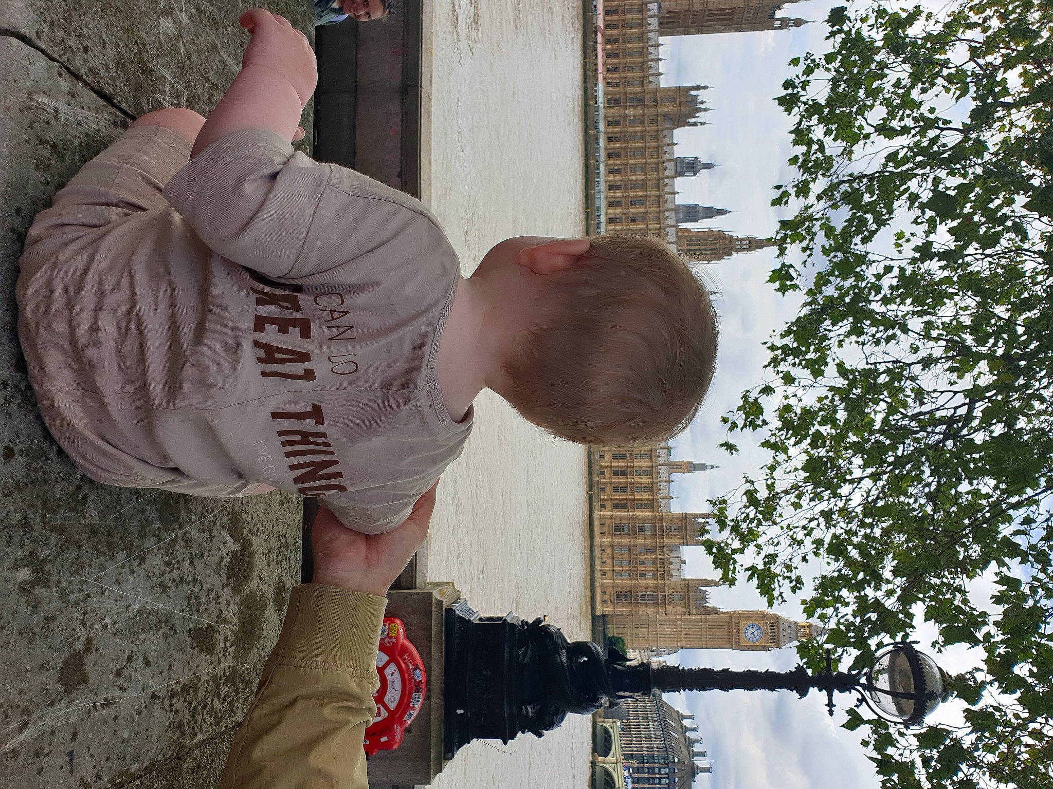 Rudi is registered to the contest to win money with this photo: arm, carmine, concrete, elbow, fun, human_leg, joint, joy, knee, leisure, person, plant, shoe, sky, sneakers, soil, t_shirt, thigh, toddler, tree