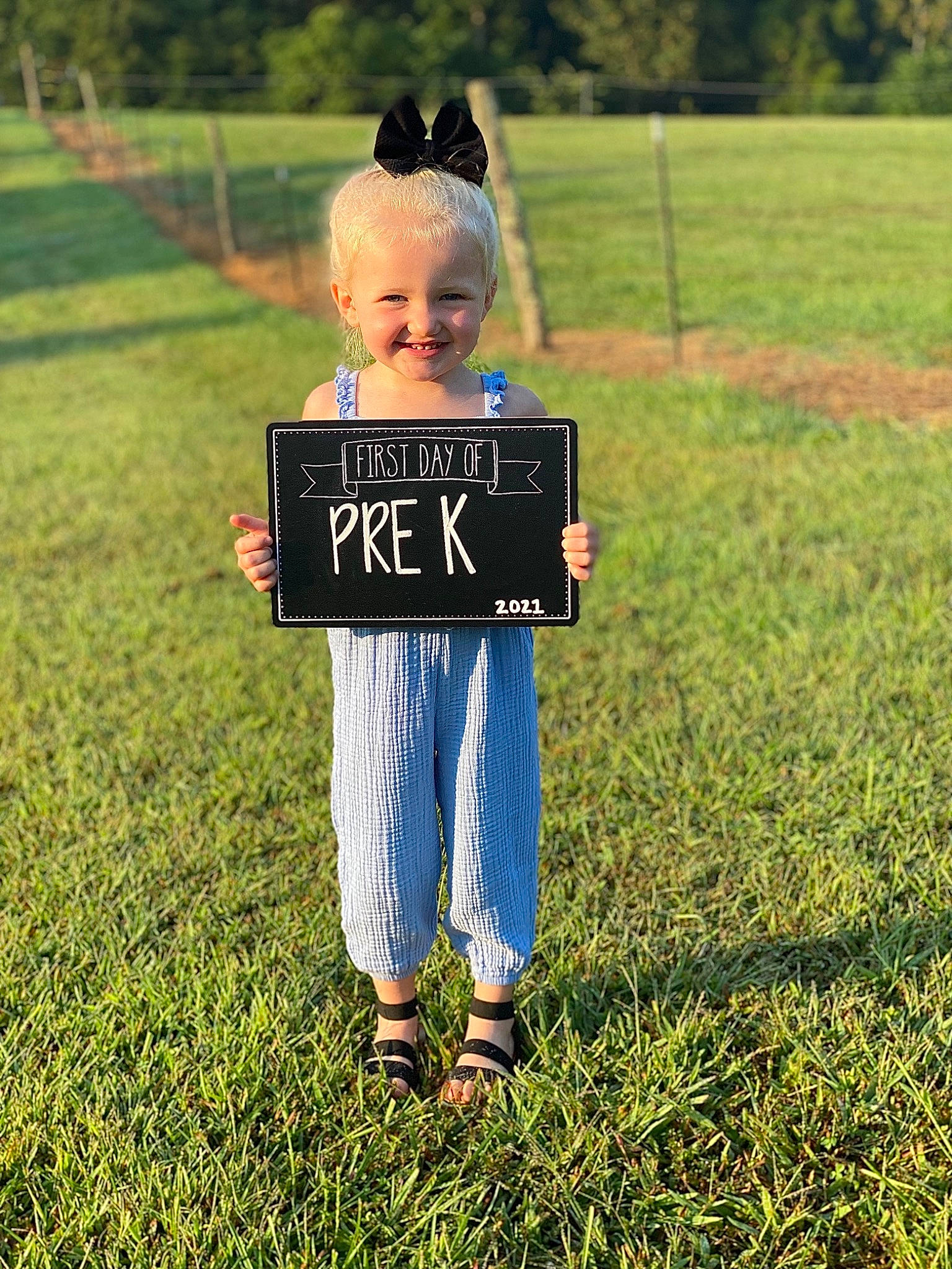 Addyson joined the competition — help win amazing prizes! child, fun, gesture, grass, grass_family, grassland, happy, joy, landscape, lawn, meadow, natural_environment, people_in_nature, person, plant, recreation, smile, standing, summer, t_shirt