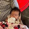 Nalani joined the competition — help win amazing prizes! baby, sleeping, mitten, blanket, minnie_mouse, person, arm, checkered_shirt, red_cushion, indoor, cozy, infant, cute, resting, child, soft_fabric, patterned_clothing, peaceful, young, portrait