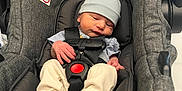Leo is registered to the contest to win money with this photo: baby, infant, car_seat, evenflo, hat, clothing, straps, safety, newborn, cute, sleepy, child, seat, fabric, soft, hands, feet, indoor, portrait, person