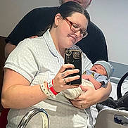 Leo joined the competition — help win amazing prizes! newborn, baby, woman, man, hospital, bed, mirror, selfie, glasses, smile, clothing, person, holding, family, parent, newborn_hat, car_seat, wristband, sink, intimate