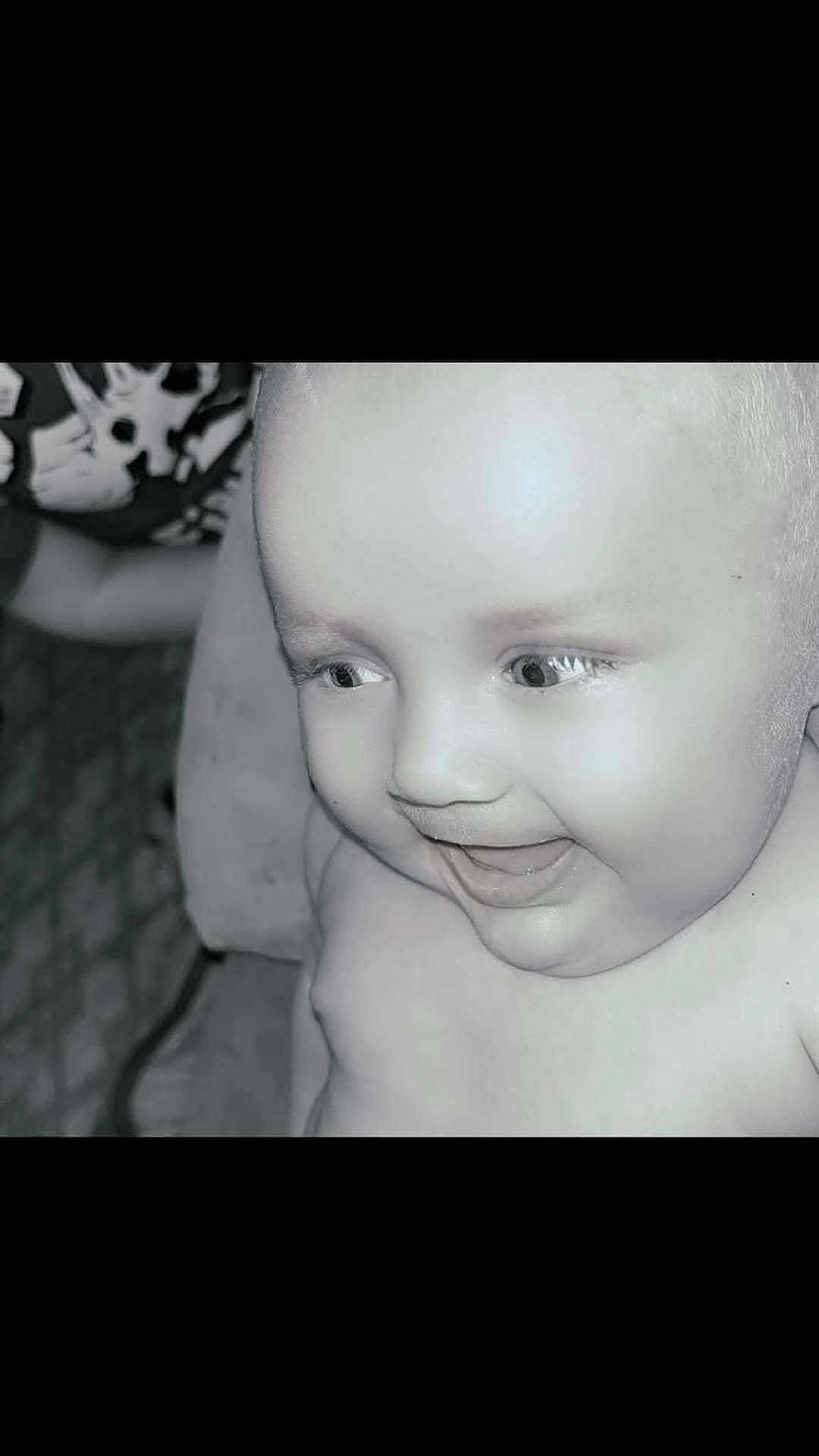 Austin is registered to the contest to win money with this photo: baby, child, smiling, face, close_up, black_and_white, joyful, innocence, eyes, expression, portrait, happiness, infant, skin, person, young, head, cheeks, baby_toddler, cute