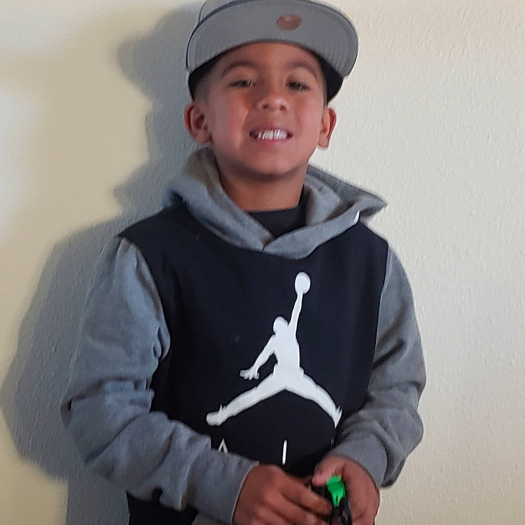 Adan joined the competition — help win amazing prizes! cap, child, clothing, cool, finger, headgear, headwear, hoodie, joy, outerwear, person, sleeve, smile, t_shirt