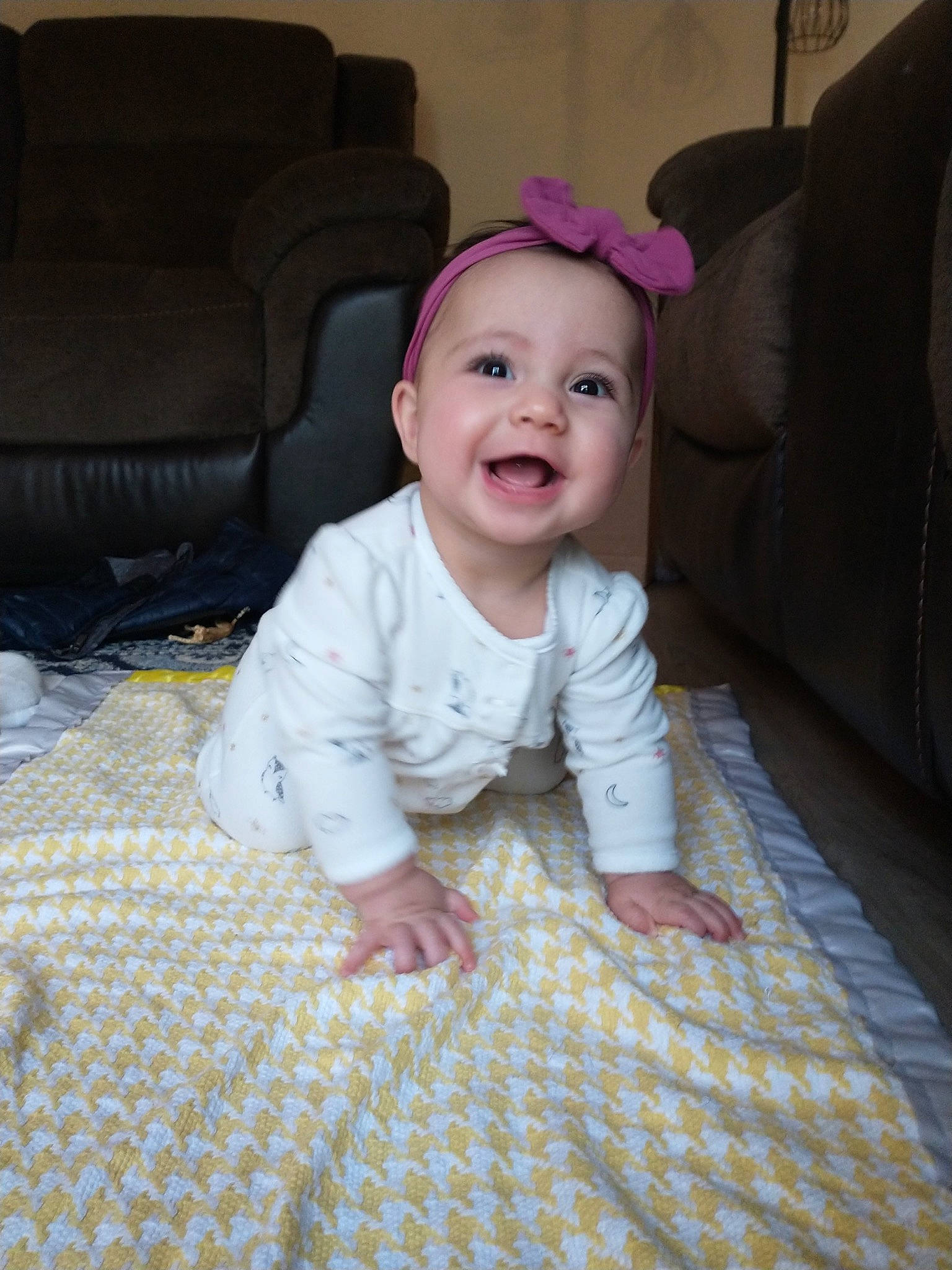 Flora is registered to the contest to win money with this photo: baby, baby_toddler_clothing, cheek, comfort, couch, crawling, eye, floor, flooring, fun, grass, hardwood, joy, linens, person, sitting, skin, sleeve, smile, textile