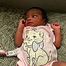 baby, infant, child, portrait, lying_down, bed, bedding, pink_onesie, cat_design, pacifier_clip, hands, arms, face, eyes, indoor, home, patterned_blanket, newborn, cute, casual_photo