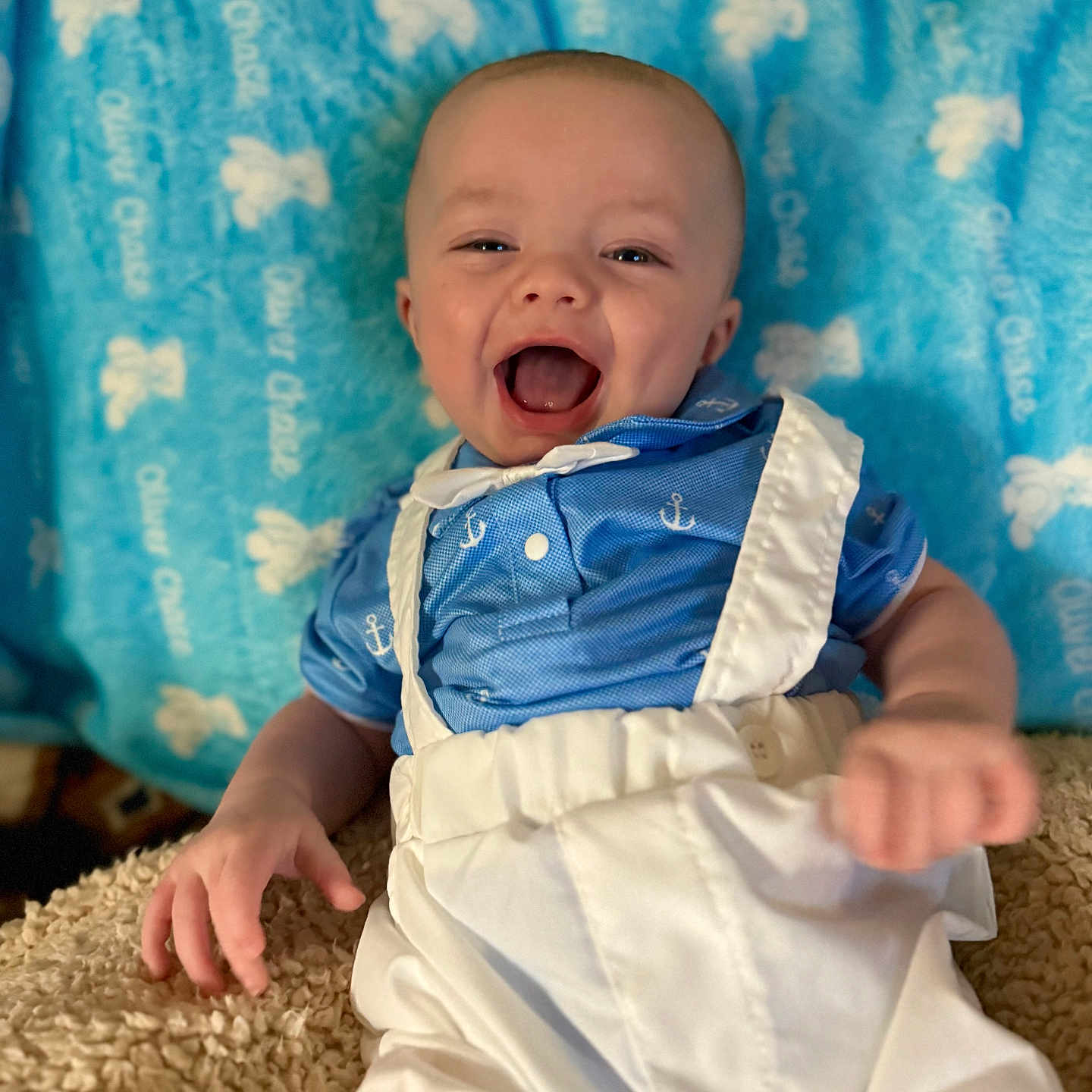 Oliver joined the competition — help win amazing prizes! baby, background, blanket, blue_shirt, child, clothing, cute, expression, face, hand, happy, indoor, infant, joy, lying_down, person, portrait, smiling, texture, white_suspender