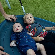 Jaxon joined the competition — help win amazing prizes! baby, toddler, child, swing, playground, grass, blue_clothing, shirt, shorts, hands, outdoor, fun, smiling, kids, rope, toy, relaxing, people, park, play