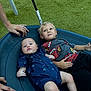 baby, toddler, child, swing, playground, grass, blue_clothing, shirt, shorts, hands, outdoor, fun, smiling, kids, rope, toy, relaxing, people, park, play