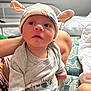 Jaxon joined the competition — help win amazing prizes! baby, infant, hat, ears, clothing, cute, person, child, bed, blanket, hand, sleeve, face, eyes, mouth, skin, indoor, soft_light, expression, cartoon