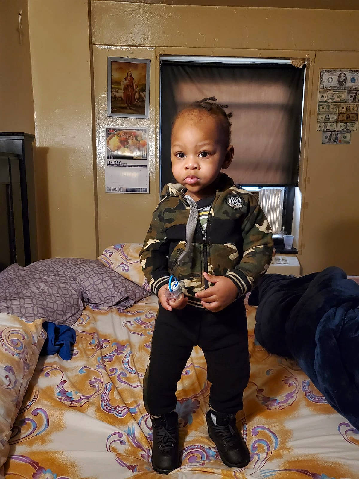 Antwan joined the competition — help win amazing prizes! baby_toddler_clothing, bag, child, comfort, costume, flooring, fun, fur, military_camouflage, military_person, military_uniform, pattern, person, picture_frame, room, shoe, sitting, sleeve, soldier, toddler