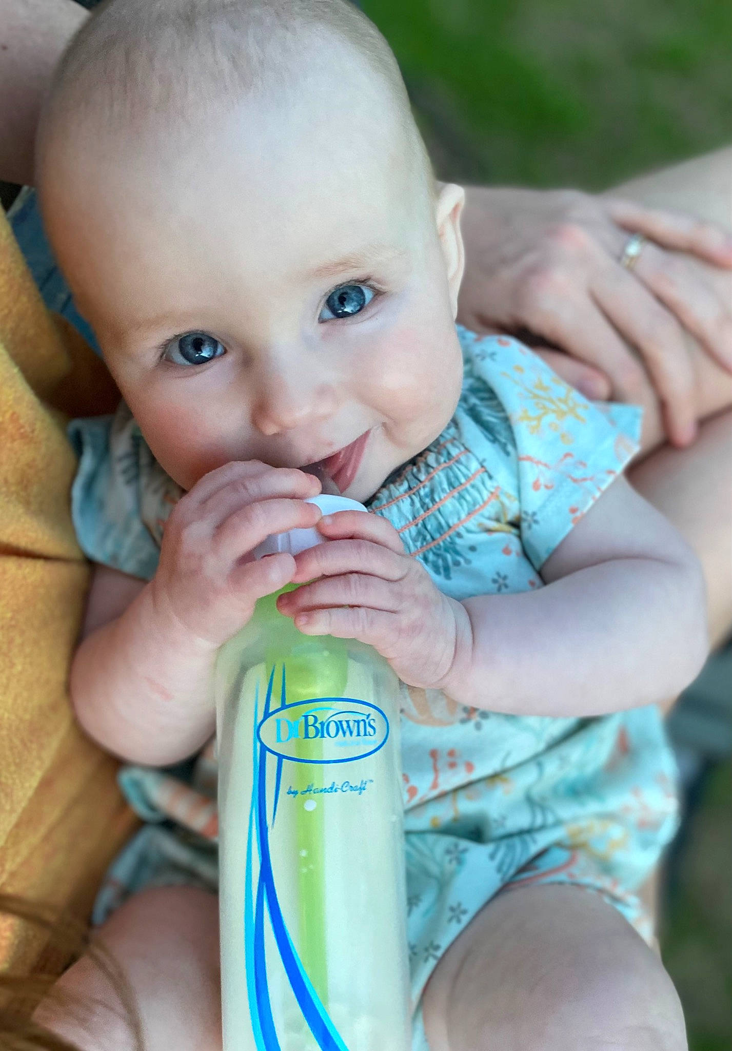 Kensleigh is registered to the contest to win money with this photo: baby, baby_toddler_clothing, bottle, cheek, child, drink, drinking, drinkware, finger, fluid, hand, happy, iris, liquid, person, plastic_bottle, product, skin, smile, toddler