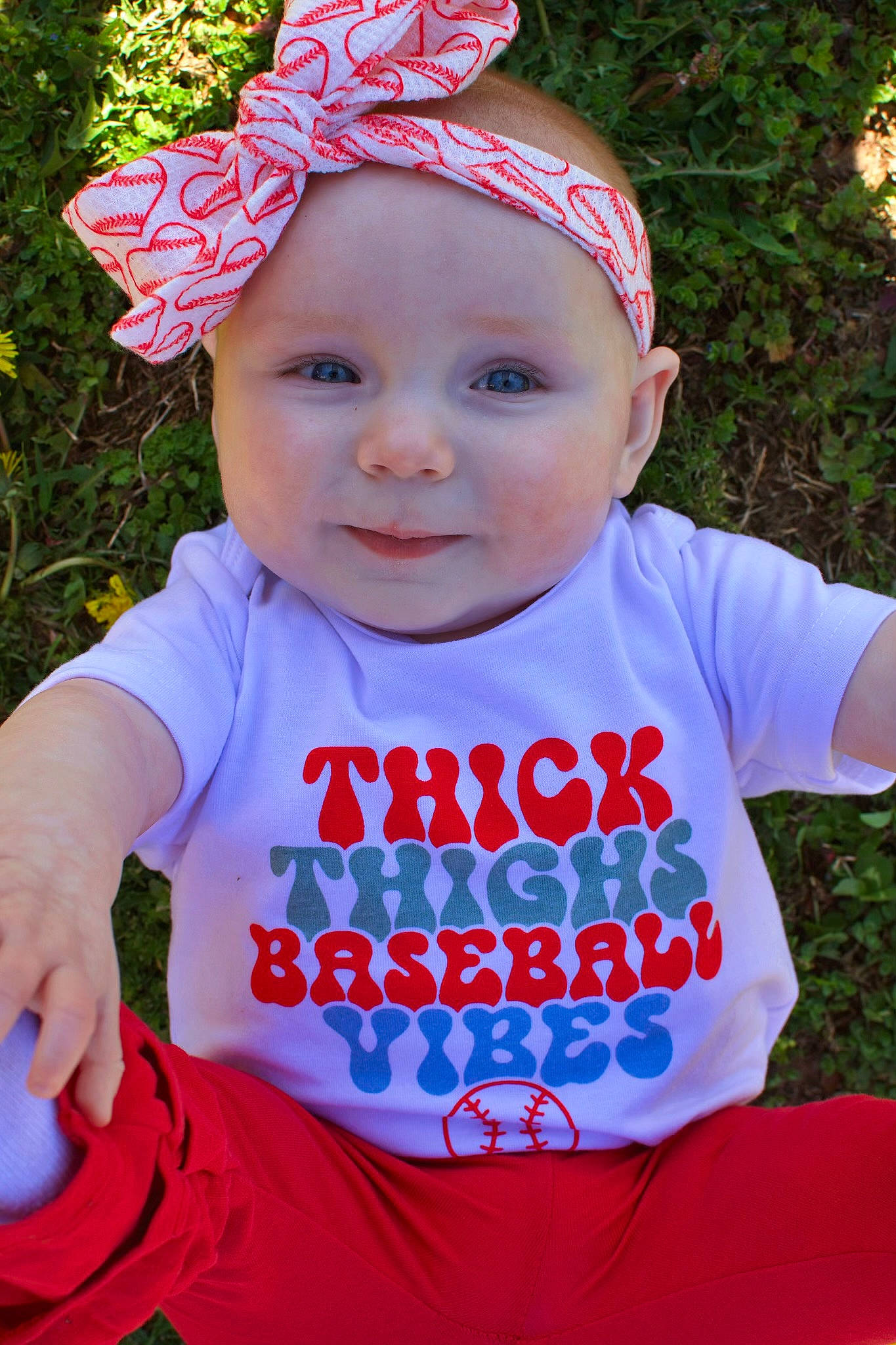 Kensleigh is registered to the contest to win money with this photo: baby_toddler_clothing, cap, child, cool, costume_hat, facial_expression, grass, happy, headgear, headwear, leaf, leisure, person, pink, plant, red, sleeve, smile, summer, t_shirt