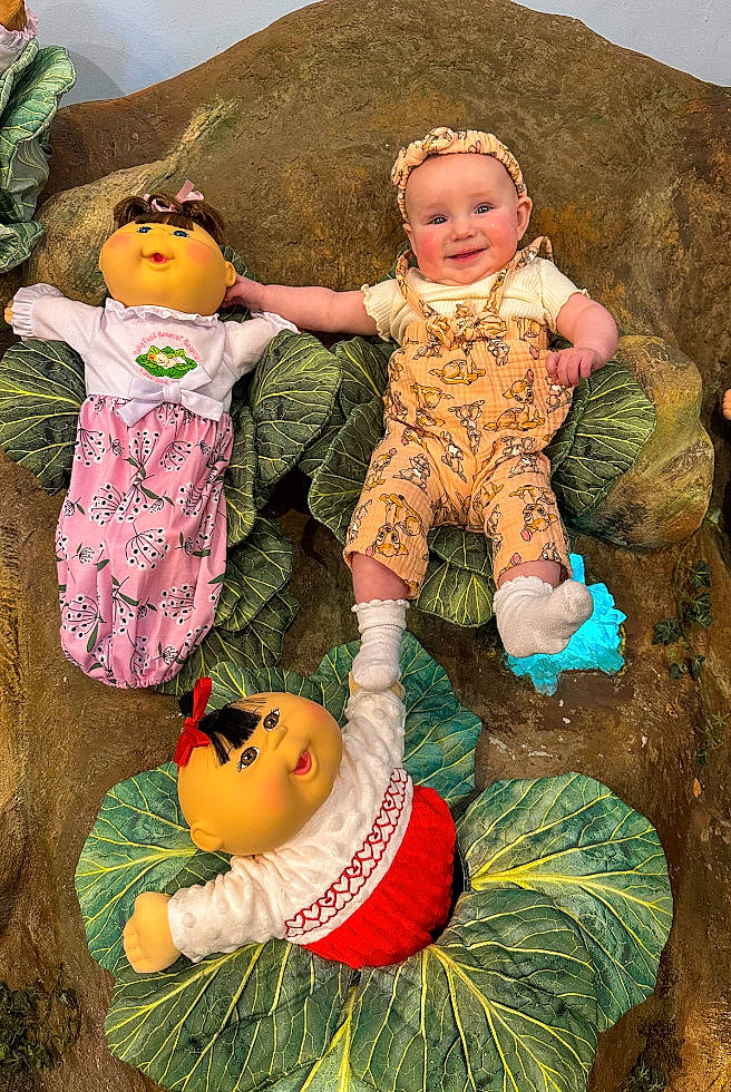 Kensleigh is registered to the contest to win money with this photo: art, baby, baby_toddler_clothing, calabaza, child, doll, fun, grass, green, happy, headwear, human, illustration, joy, leisure, pattern, people_in_nature, person, pumpkin, sitting