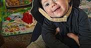 Colsen is registered to the contest to win money with this photo: baby, child, hat, smile, indoor, playmat, toys, person, face, clothing, cute, holding, happy, infant, colorful, background, home, young_child, bucket_hat, playtime