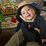 baby, background, bucket_hat, child, clothing, colorful, cute, face, happy, hat, holding, home, indoor, infant, person, playmat, playtime, smile, toys, young_child
