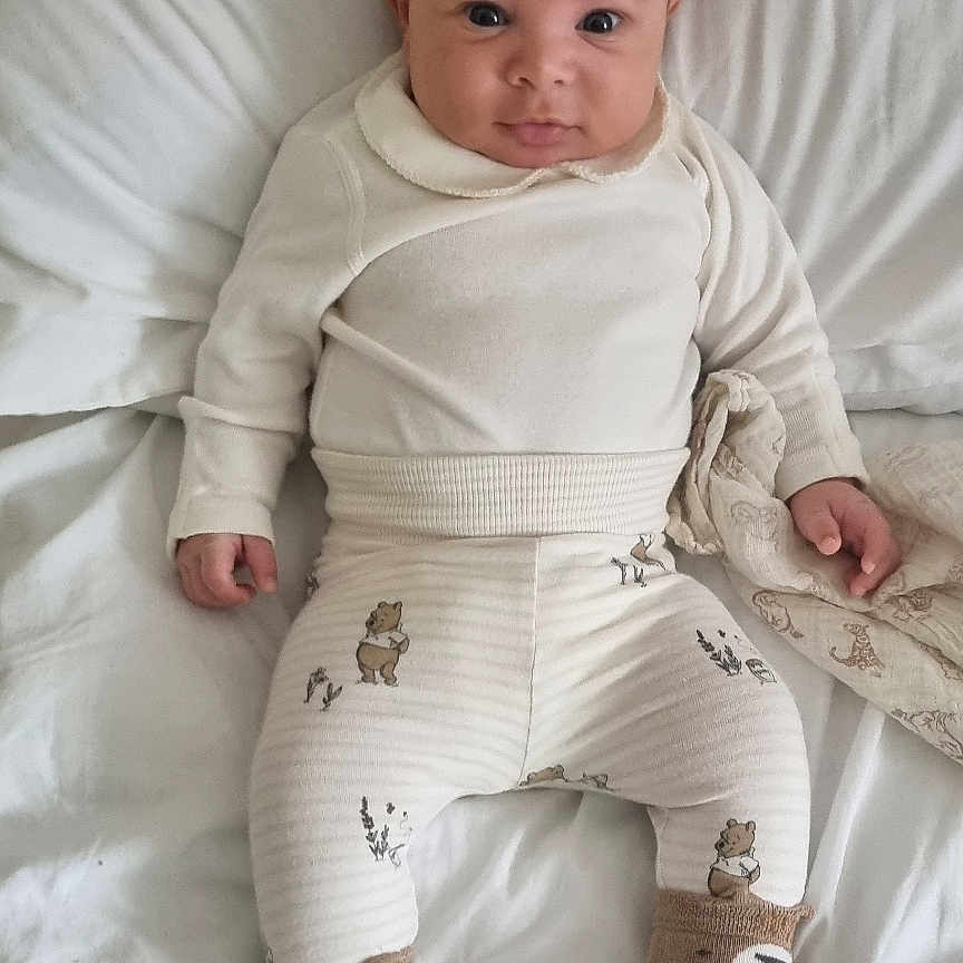 Bertie is registered to the contest to win money with this photo: baby, bed, bodypart, clothing, couch, cushion, face, finger, furniture, hand, head, homedecor, hosiery, linen, newborn, pants, person, photography, portrait, sock