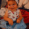 Sterling is registered to the contest to win money with this photo: baby, child, infant, smiling, portrait, indoor, bedroom, bed, blanket, pillows, dress, bow, headband, hello_kitty, hearts, face_stickers, barefoot, sitting, happy, cozy