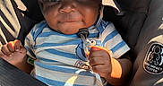 Dedrick is registered to the contest to win money with this photo: baby, infant, child, car_seat, safety_harness, sun_hat, striped_shirt, seated, indoors, vehicle, portrait, face, eyes, hands, smiling, sunlight, carriage, fabric, safety_label, photography