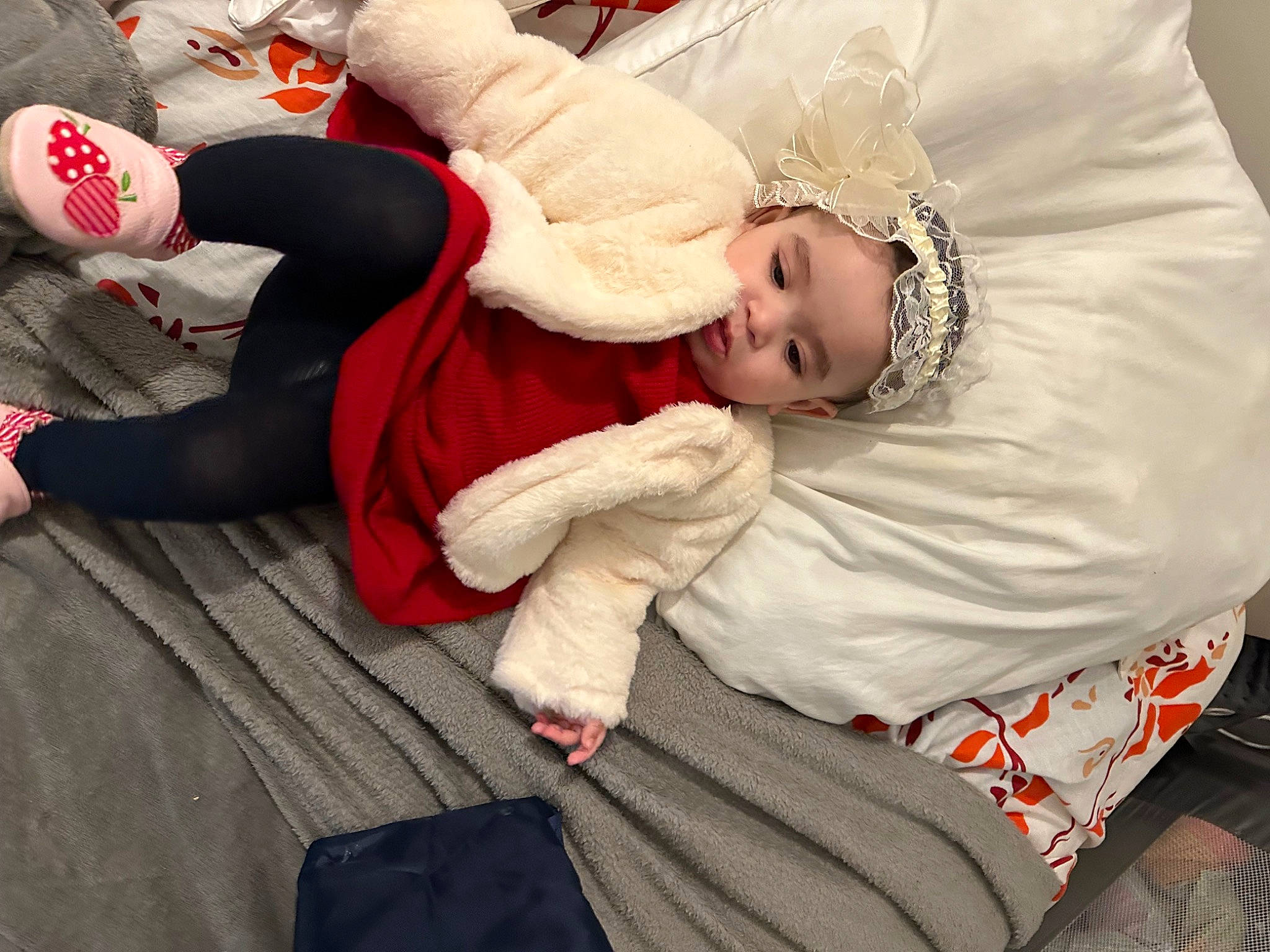 Miral participe au concours pour gagner de l'argent avec cette photo : baby, baby_toddler_clothing, carmine, child, comfort, event, flooring, foot, fun, fur, happy, hat, headwear, human_leg, knee, lap, person, sitting, sock, thigh