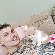 Milo joined the competition — help win amazing prizes! animal, beige, cat, chain_necklace, companion, couch, cute, furniture, home, indoor, kitten, man, pet, pink_pillow, relaxing, short_hair, smile, tattoo, tattoos, young_adult