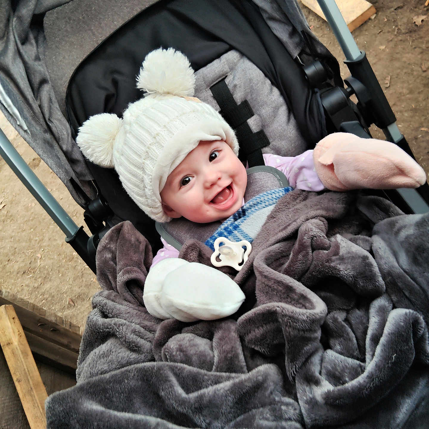 Remi joined the competition — help win amazing prizes! baby, smiling, stroller, blanket, hat, mittens, outdoor, child, cold_weather, cozy, happy, infant, cute, warm_clothing, person, portrait, baby_accessories, playful, winter, seat