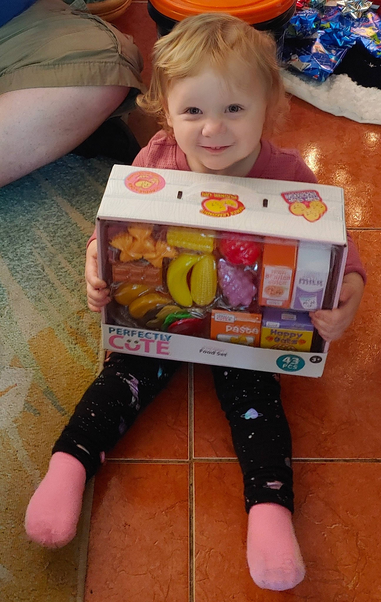 Yelena joined the competition — help win amazing prizes! baby, baby_toddler_clothing, baby_toys, blond, box, child, convenience_food, doll, joy, person