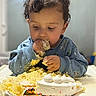 Ethan joined the competition — help win amazing prizes! birthday_cake, blue_sweatshirt, cake, celebration, child, closeup, colorful, crumbs, curly_hair, eating, food, frosting, happy, highchair, indoor, messy, person, smile, sprinkles, toddler