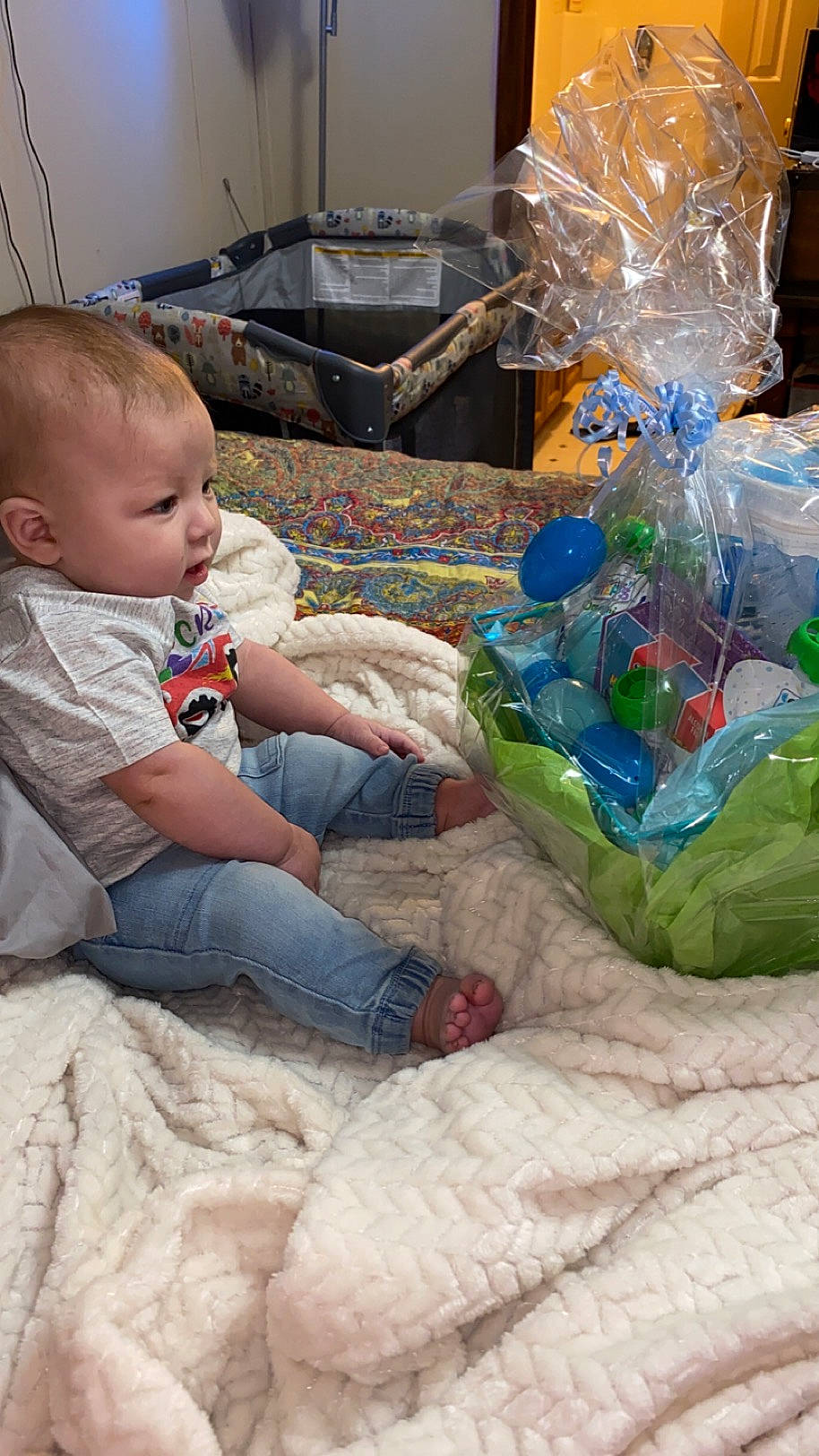 Colton is registered to the contest to win money with this photo: baby, baby_toddler_clothing, child, comfort, event, flooring, fun, lap, linens, person, plastic, plastic_bag, plastic_bottle, plastic_wrap, play, product, room, sitting, sock, toddler