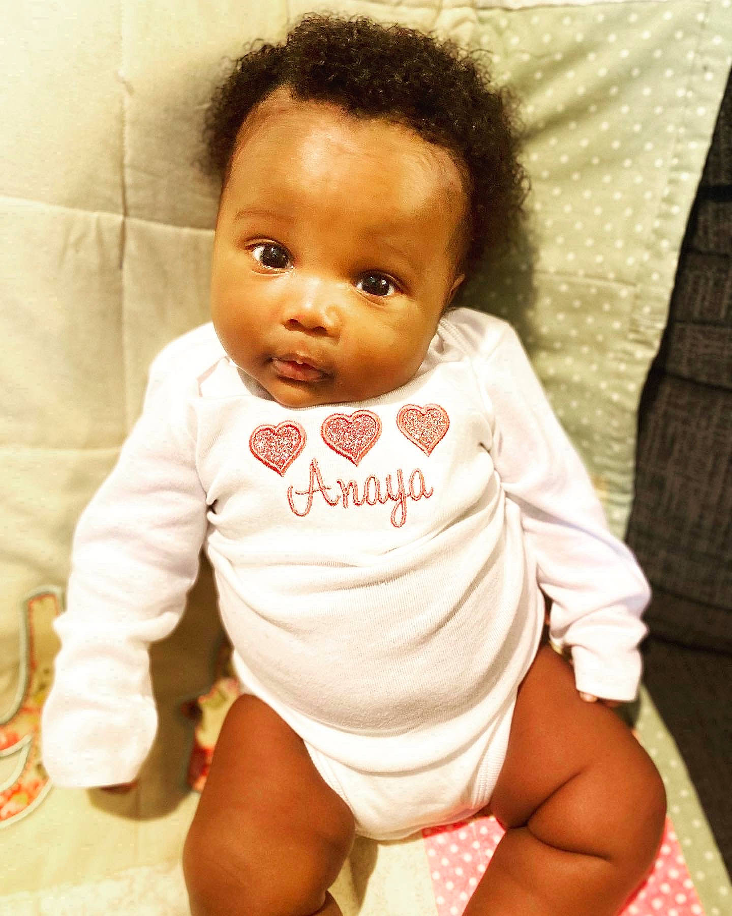 Anaya is registered to the contest to win money with this photo: baby, baby_toddler_clothing, cheek, comfort, eye, eyebrow, eyelash, happy, head, iris, lip, mouth, no_expression, nose, person, product, sitting, skin, sleeve, thigh