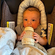 Malachi is registered to the contest to win money with this photo: baby, bottle, blanket, car_seat, child, cute, feeding, infant, milk, person, portrait, resting, soft, toddler, warm, wrapped, young, cozy, cushion, comfort