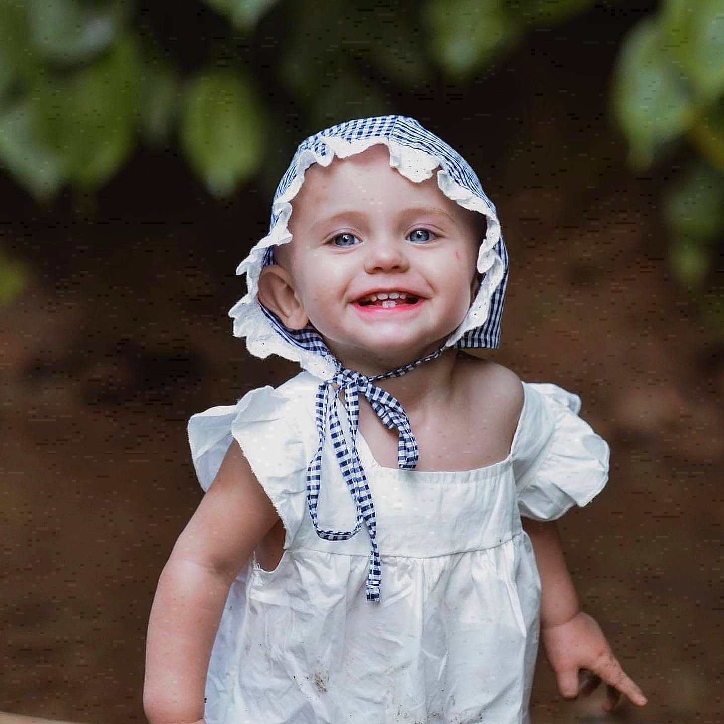 Hensley is registered to the contest to win money with this photo: baby, baby_toddler_clothing, dress, electric_blue, embellishment, eye, face, flash_photography, fun, happy, head, headband, headgear, headpiece, headwear, iris, jewellery, joy, necklace, person