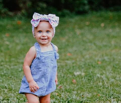 Hensley is registered to the contest to win money with this photo: baby, baby_toddler_clothing, child, clothing, day_dress, electric_blue, face, flash_photography, fun, grass, grassland, happy, headband, headwear, joy, meadow, people_in_nature, person, plant, skin